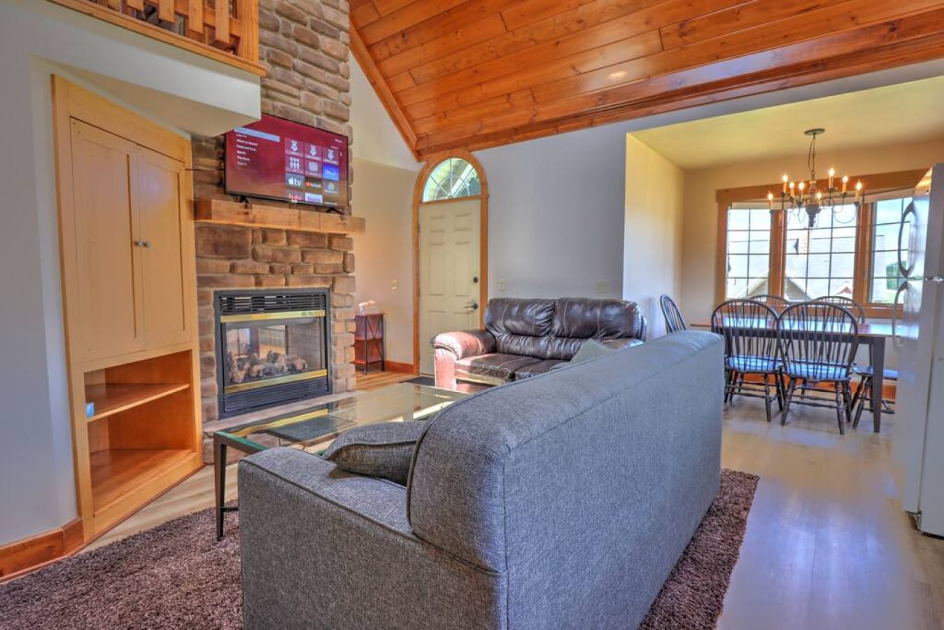 Vaulted living and dining room with fireplace inside Premier Cottage #4, Berlin Ohio