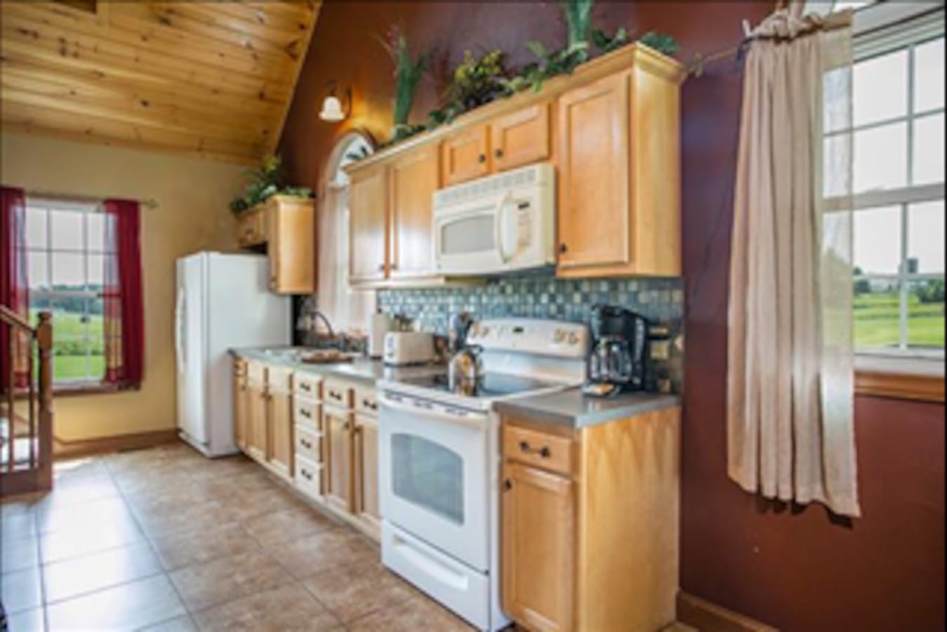 Full kitchen with vaulted wood ceiling inside Premier Cottage #7, Berlin Ohio